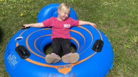 Girl relaxing in a Kickapoo River rental tube with backrest at Kickapoo Wild Adventures